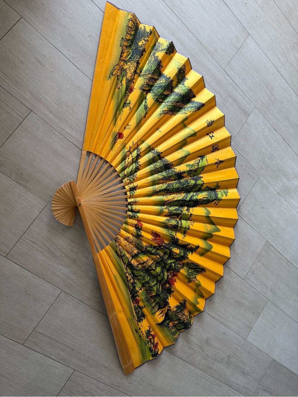 Wall hung Folding Fan in Bright Yellow with Scenic Print